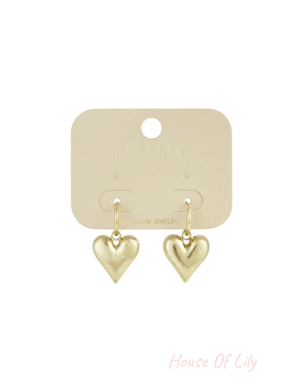 Gold-toned drop earrings with brushed-finish puffed heart pendants hanging from small hoops.