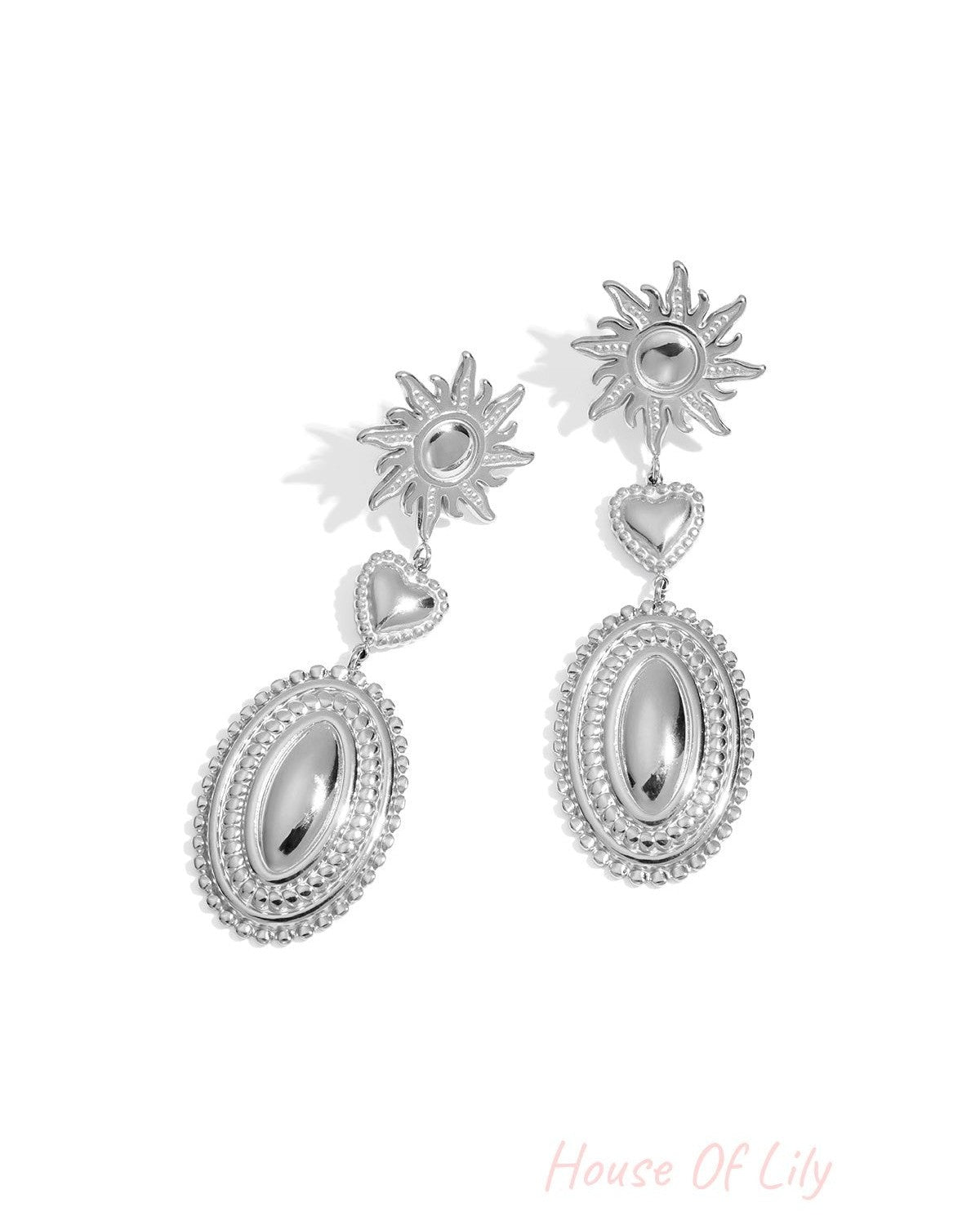 Pair of silver dangle earrings featuring the same sun, heart, and oval motifs with decorative beaded edging.