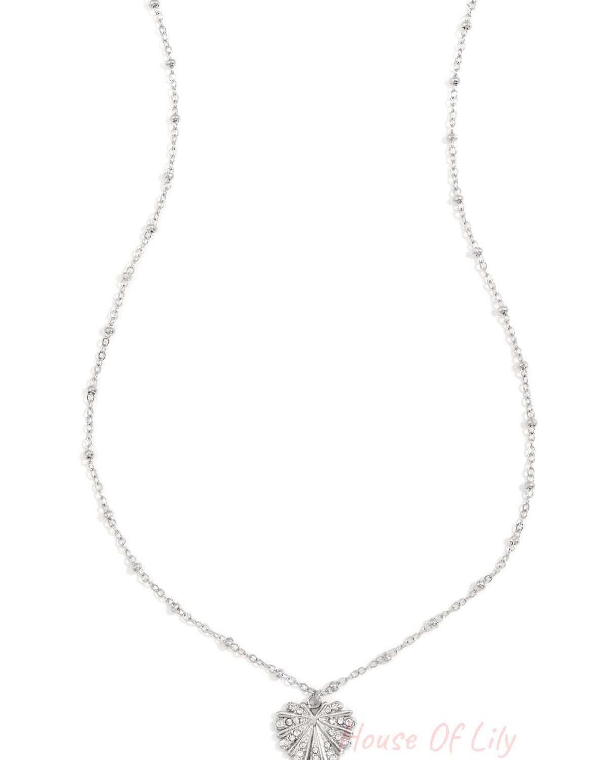 Silver crystal leaf pendant necklace with beaded chain on white background