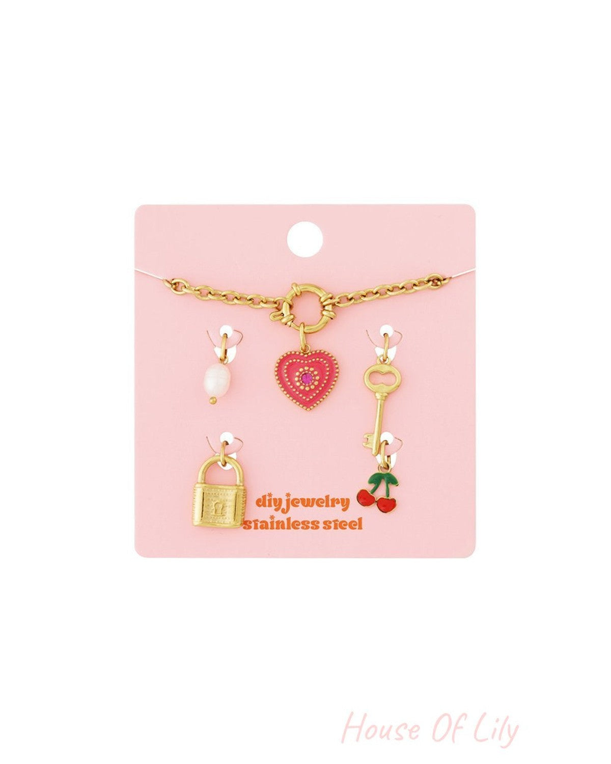 Gold chain bracelet kit with heart, lock, key, cherry, and pearl charms on a pink display card.