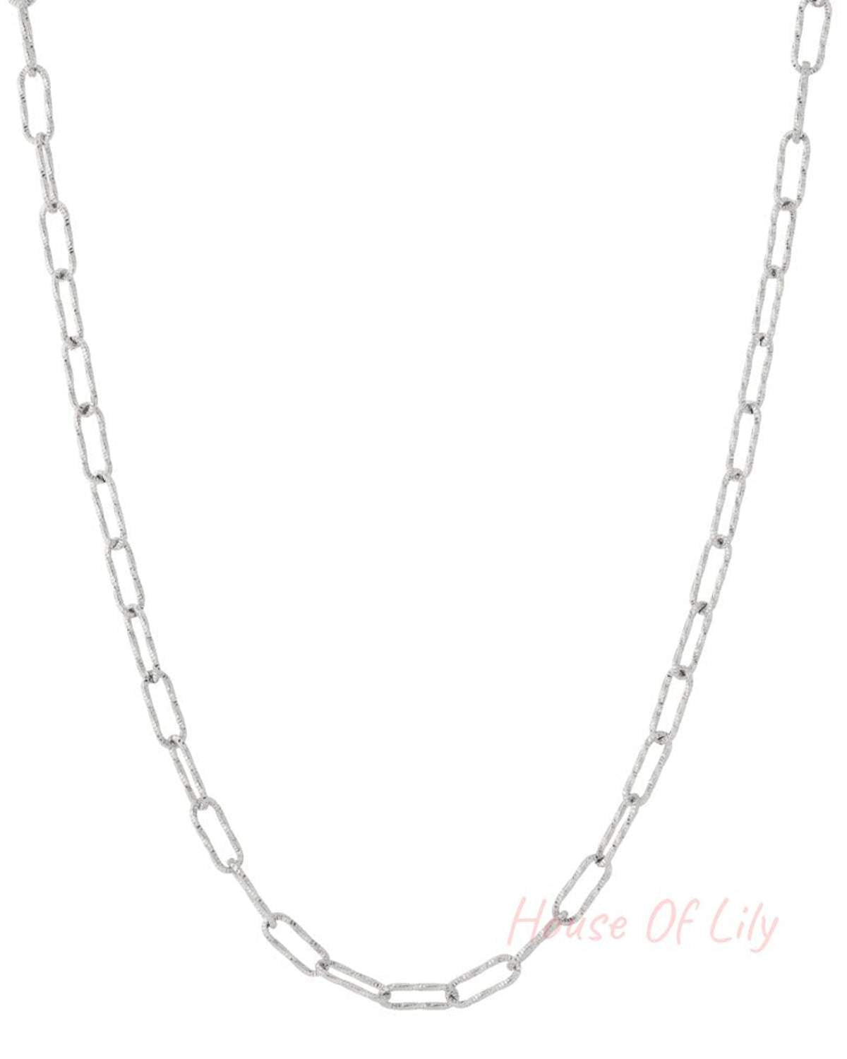 Silver textured link chain necklace laid flat on white background, showing its clean minimalist design