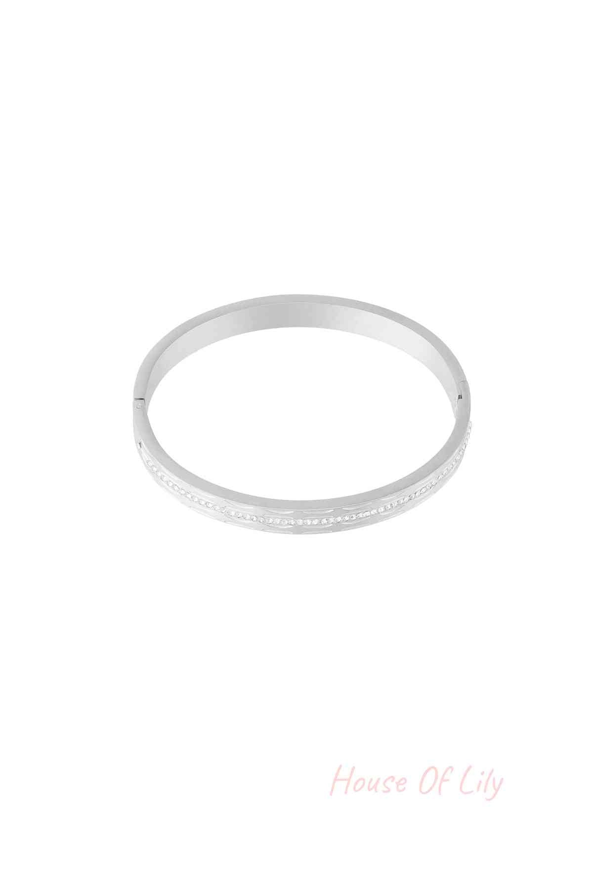 Single silver-tone bangle featuring a row of small sparkling crystals, isolated on white background