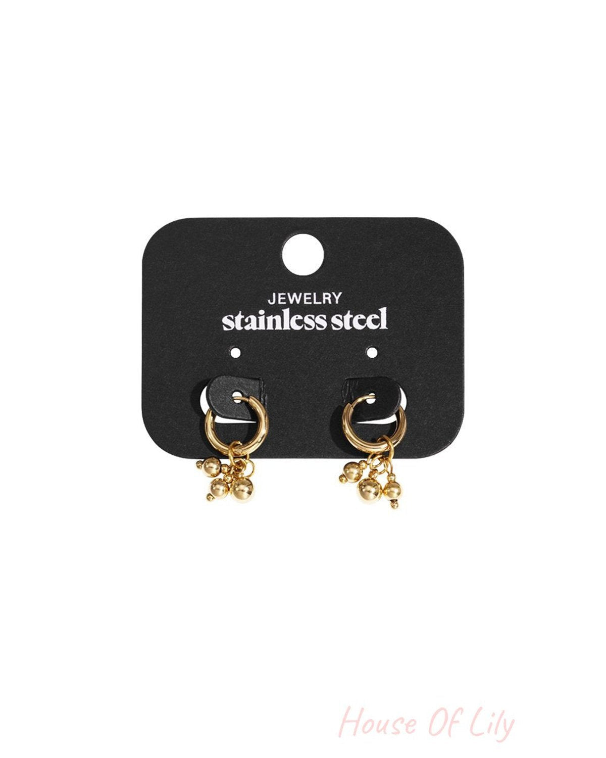 Gold stainless steel hoop earrings with hanging bead charms on a black display card.