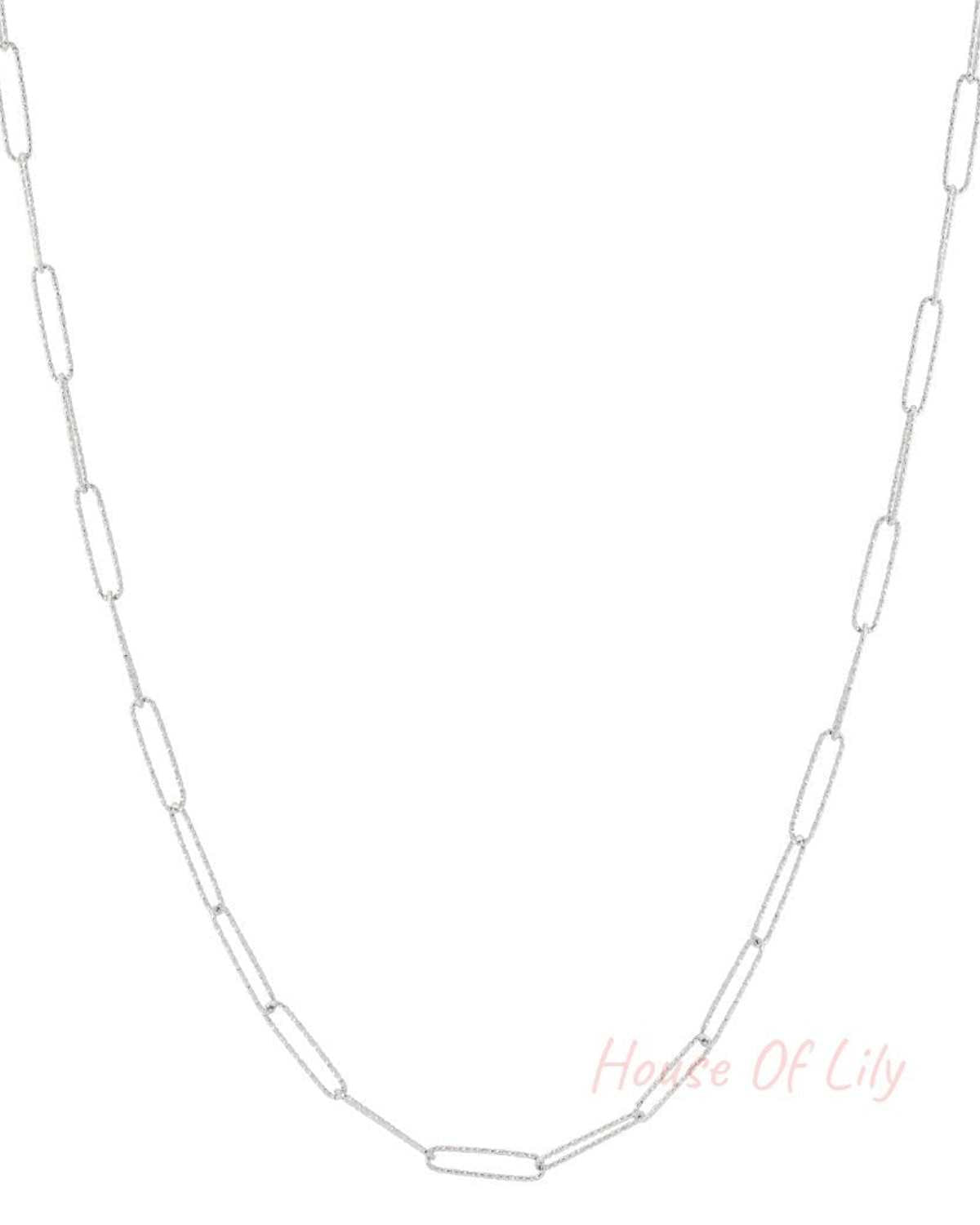 Silver elongated link chain necklace laid flat on white background