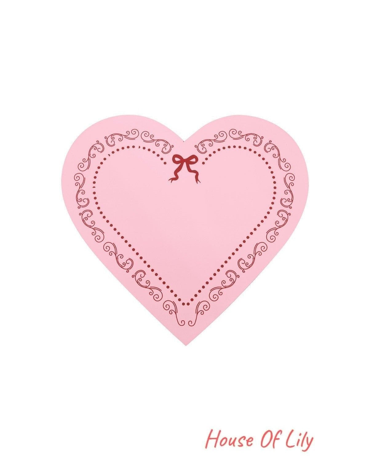 Pink heart-shaped lid featuring decorative red scrolls and a ribbon bow design