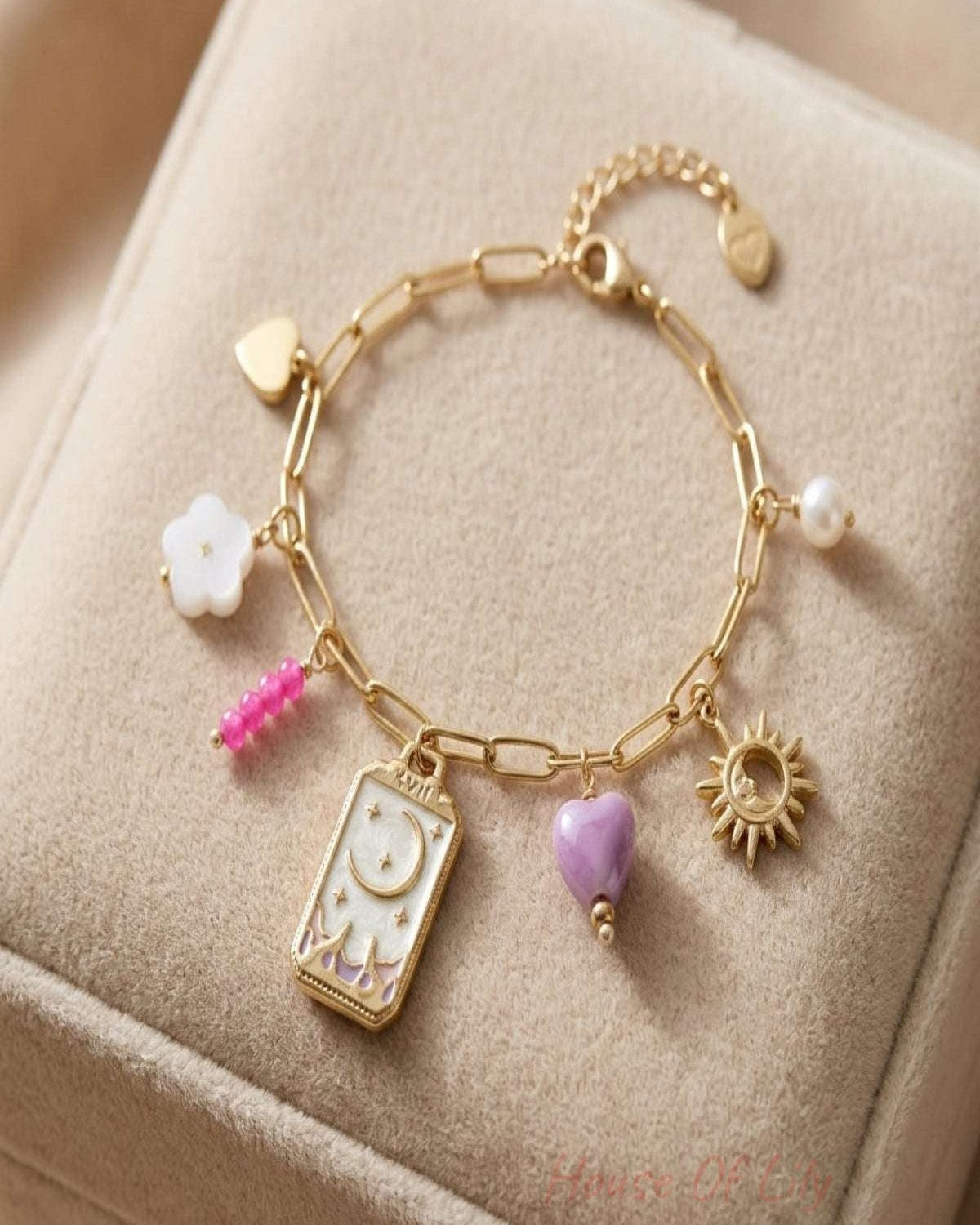 Close-up of a delicate tiny moon charm bracelet in gold or silver on a soft velvet surface with natural lighting