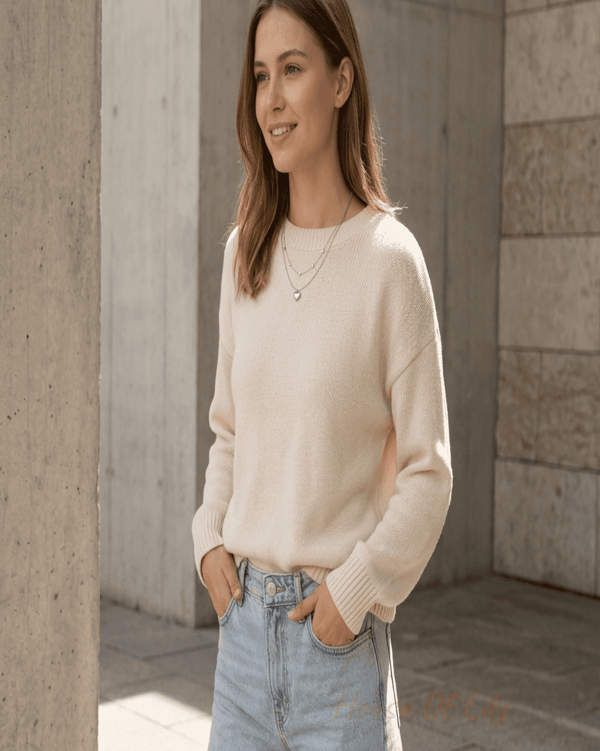 Full-body scene of a young woman wearing the layered heart necklace in a casual urban setting with natural sunlight, showcasing its delicate, feminine style.