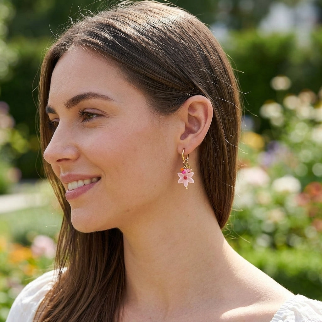 Full-body shot of a woman wearing small floral earrings outdoors, highlighting their delicate size and detailed design.