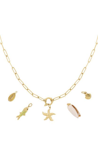 Golden chain necklace with interchangeable ocean-themed charms including starfish, fish with green enamel, shells and a cowrie shell on a white background