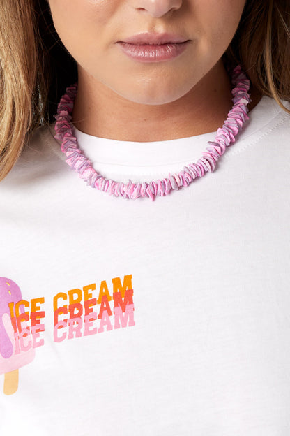 Model wearing pink shell choker necklace paired with white ice cream graphic tee