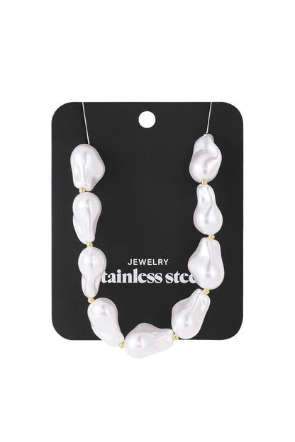 Baroque imitation pearl necklace with white, irregularly shaped beads and small gold-tone spacers on a display card.
