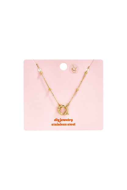 Dainty gold stainless steel necklace with a delicate chain, bead accents, and a circular spring-ring clasp.