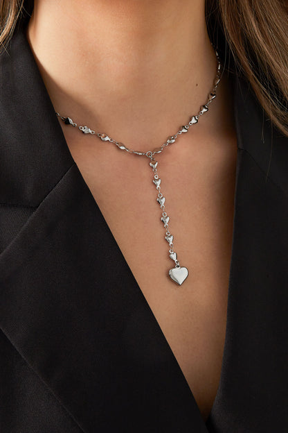 Silver heart chain necklace worn elegantly with black top on model