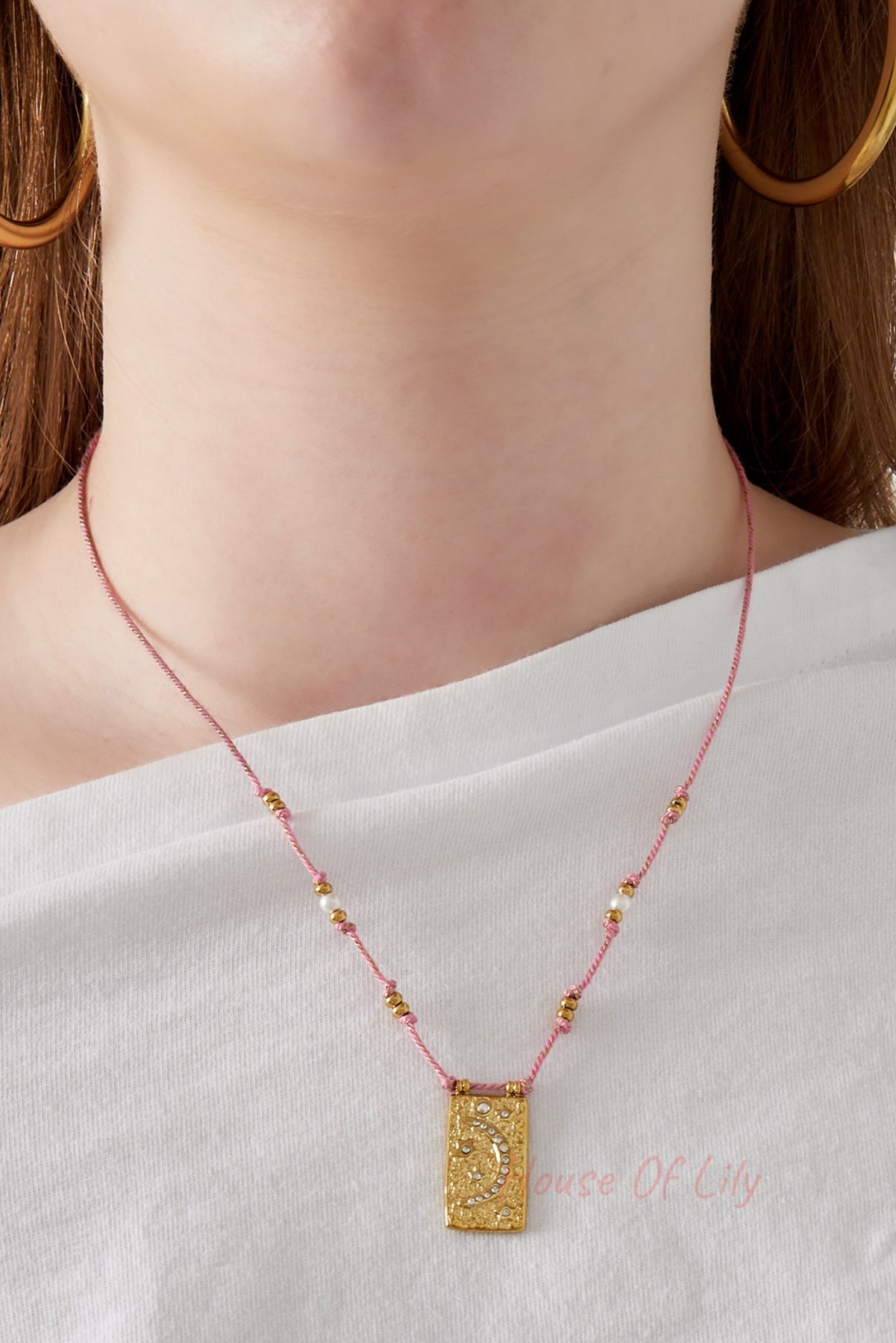 Model showing close detail of the pink cord moon pendant necklace
