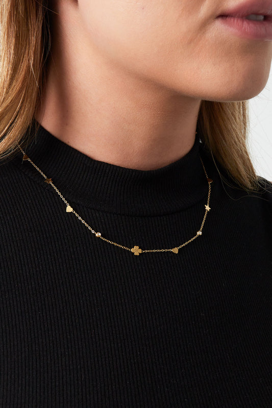 Model wearing the gold-tone delicate necklace showcasing its lightweight and subtle sparkle on neck