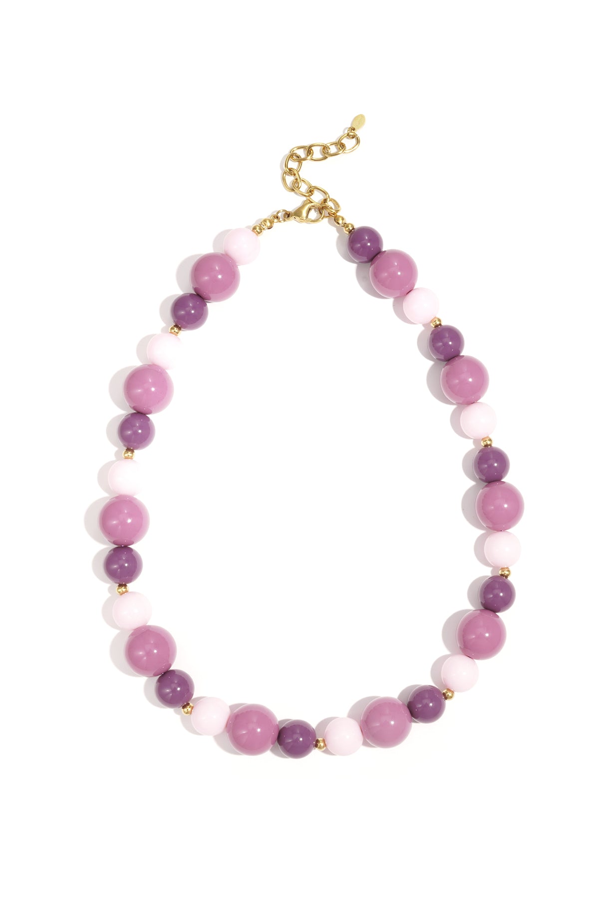 Chunky beaded necklace with dark and light blue beads interspersed with small gold beads and clasp on white background