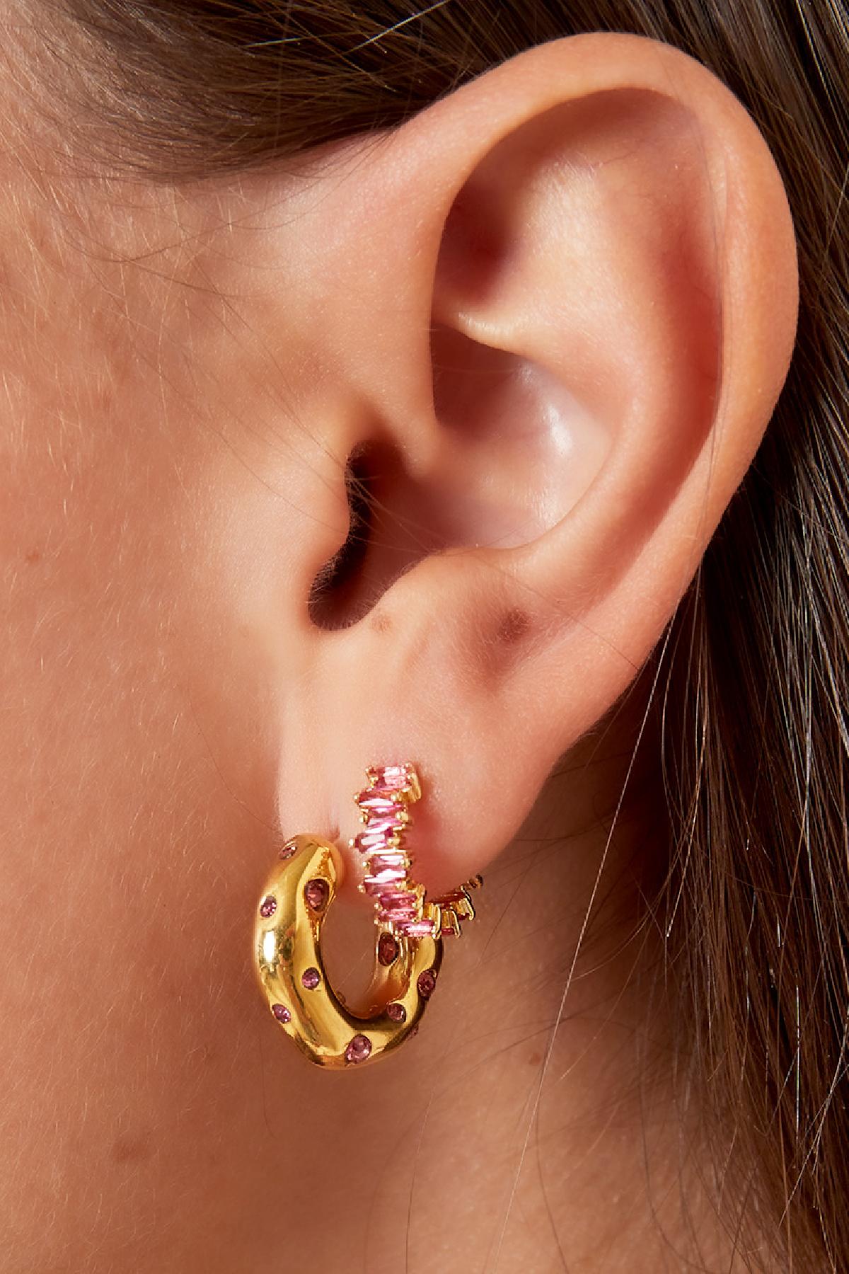 Pair of gold-tone semi-circle hoop earrings adorned with multicolored baguette crystals on a white background
