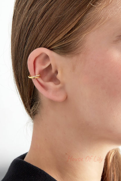 Side profile of a woman wearing the gold spiral ear cuff clipped on the ear's upper cartilage
