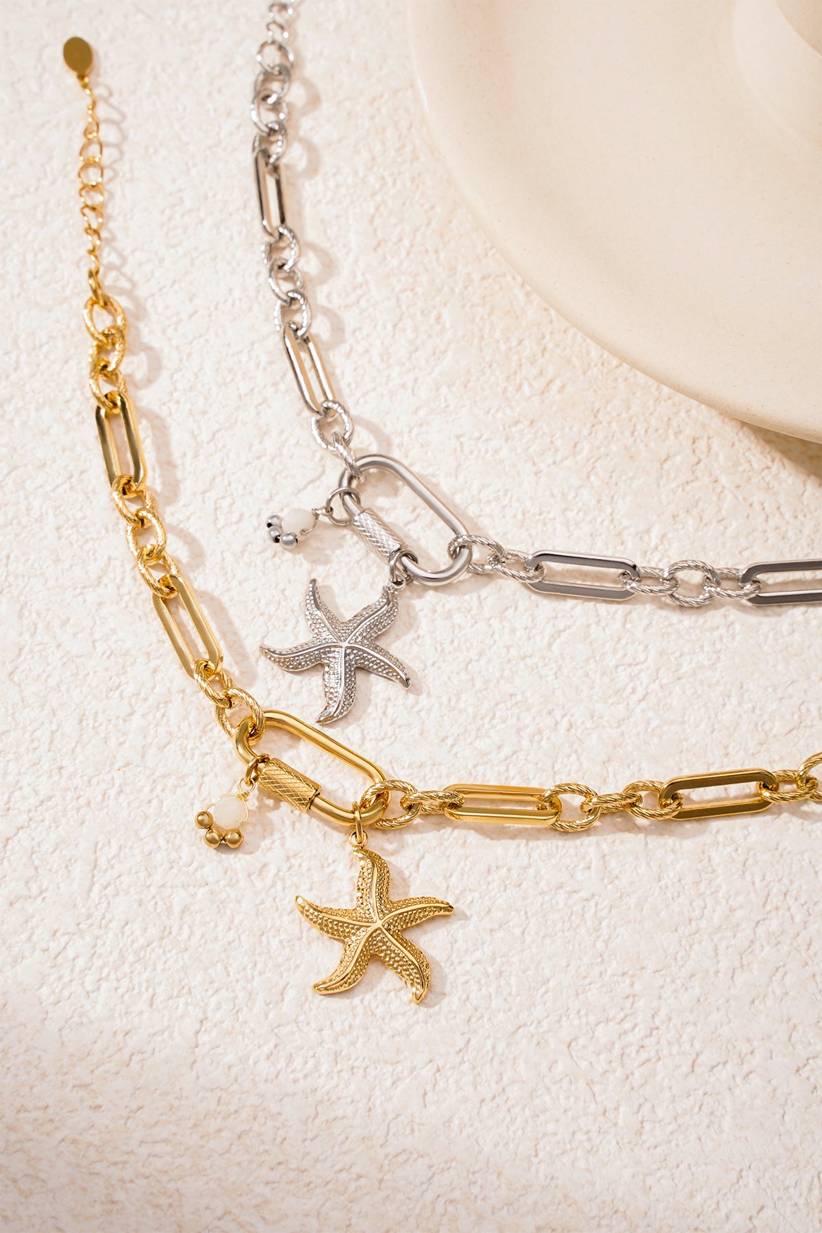 Gold starfish charm bracelet displayed on boutique black packaging card