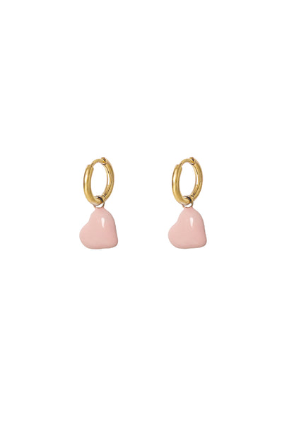 Pair of gold hoop earrings with baby pink enamel hearts displayed on white background