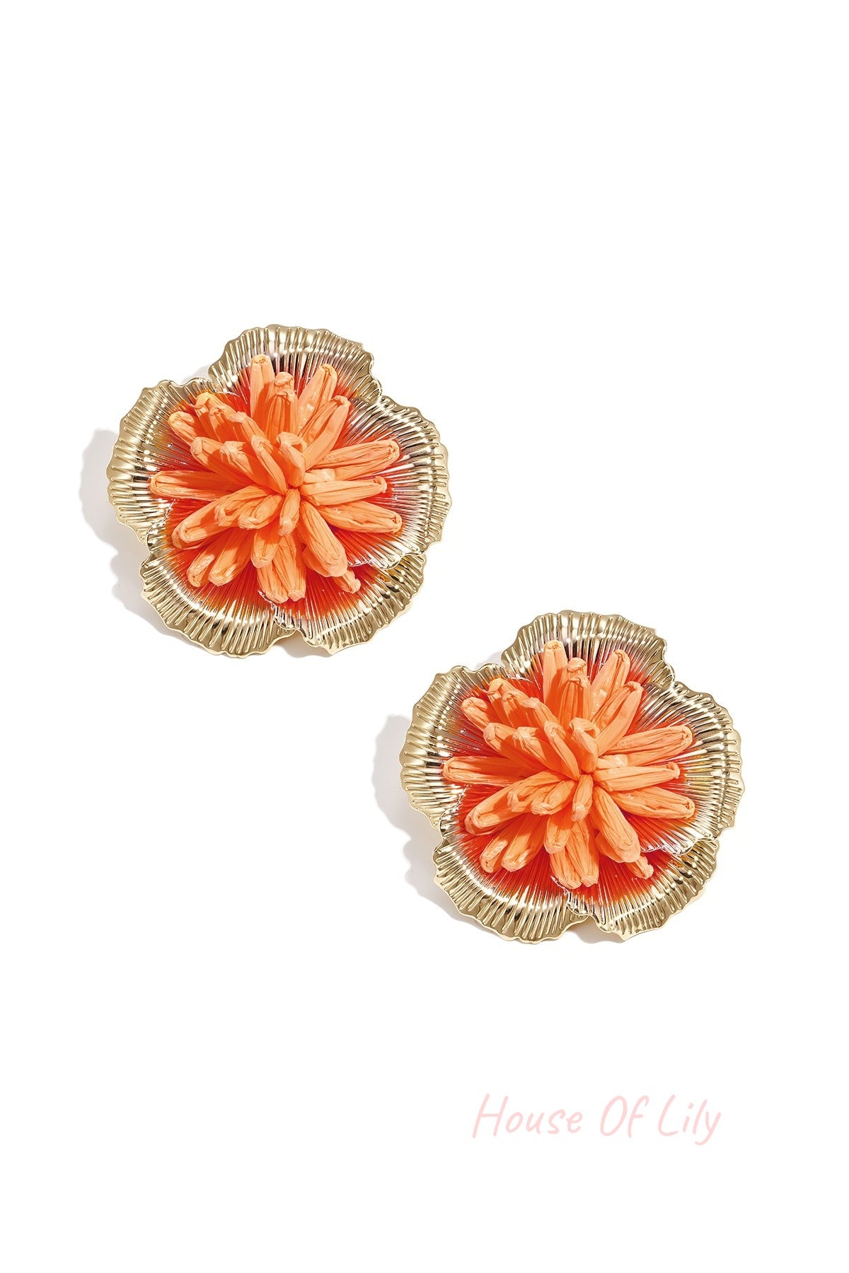 Pair of vibrant orange 3D raffia flower stud earrings with gold-tone metal frame on white background