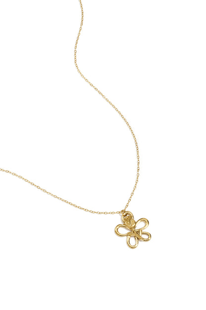 Close-up of gold delicate floral pendant necklace with sculptural flower on thin chain against white background