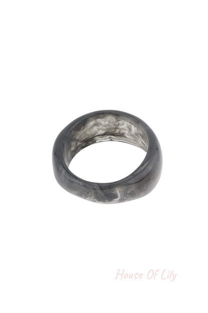 Close-up of smoky gray marbled resin bangle bracelet on white background