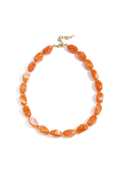 Chocolate and amber chunky beaded necklace with glossy finish and gold clasp on white background