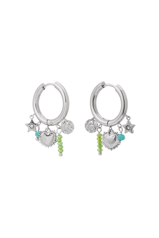 Pair of silver hoop earrings with heart, star, and green and turquoise bead charms on white background
