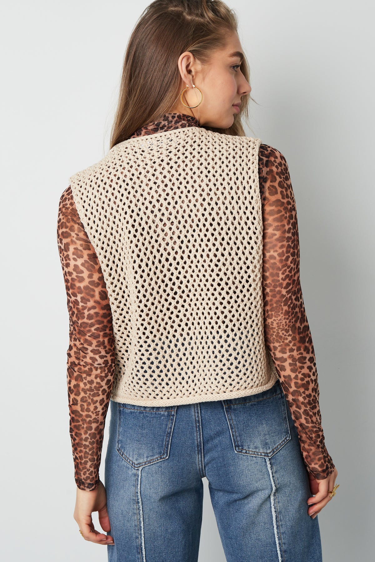 Black chunky knit women's vest with large buttons displayed flat against white background