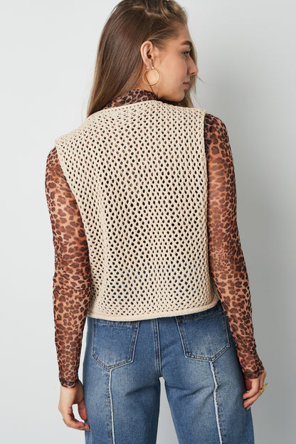 Black chunky knit women's vest with large buttons displayed flat against white background