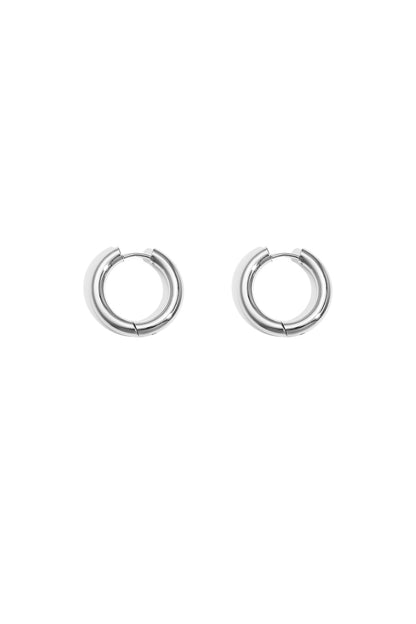 Pair of chunky silver hoop earrings on white background