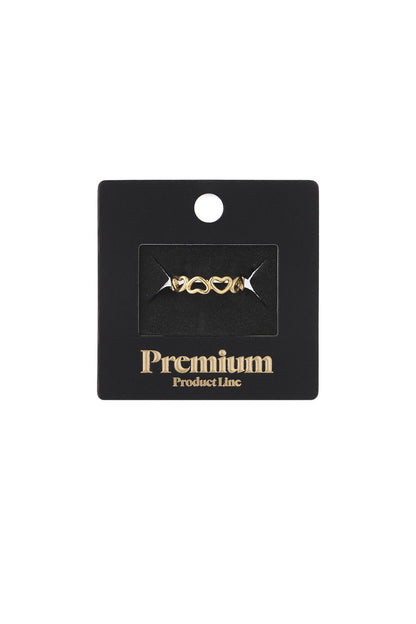 Golden Heart Era gold-tone ring featuring a delicate band of interconnected cutout heart shapes on a black display card.