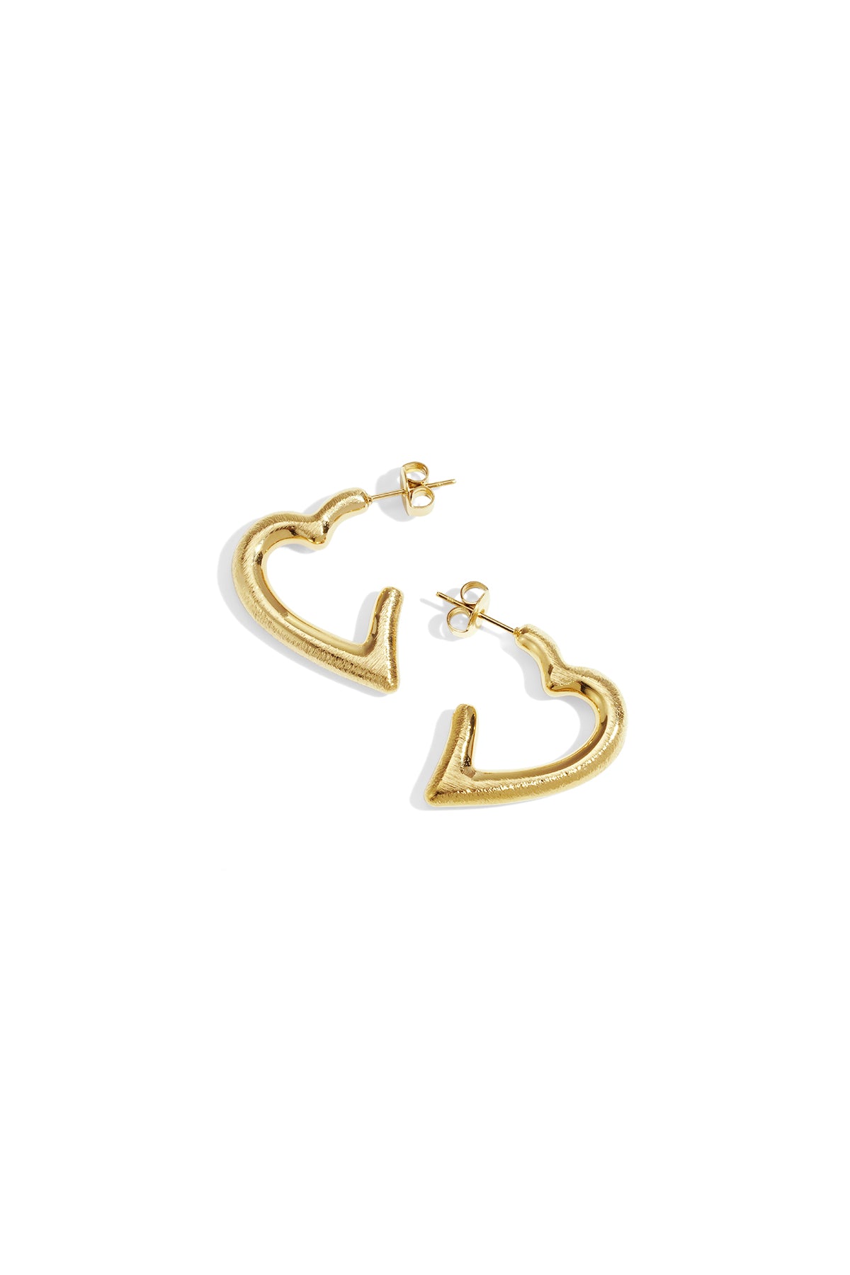 Pair of sculpted heart-shaped gold hoop earrings on white background