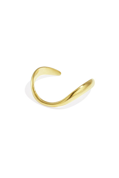Gold-toned organically sculpted open cuff bracelet with smooth curved design on white background
