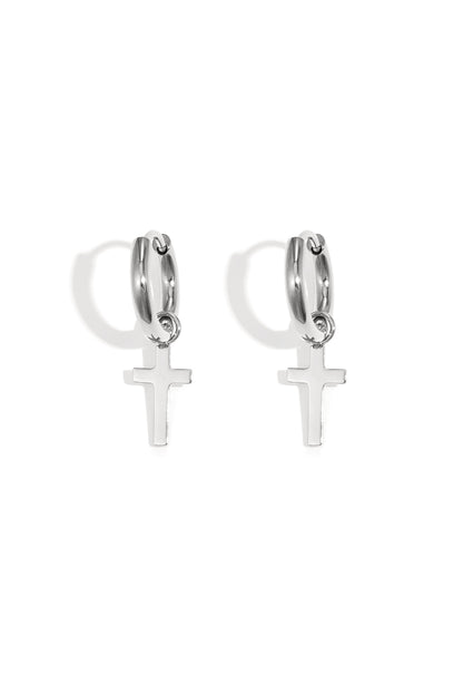 Pair of silver hoop earrings featuring delicate dangling cross pendants on a white background