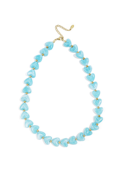 Heart Beaded Necklace with light blue marbled heart-shaped beads alternating with small gold spheres on a gold chain.