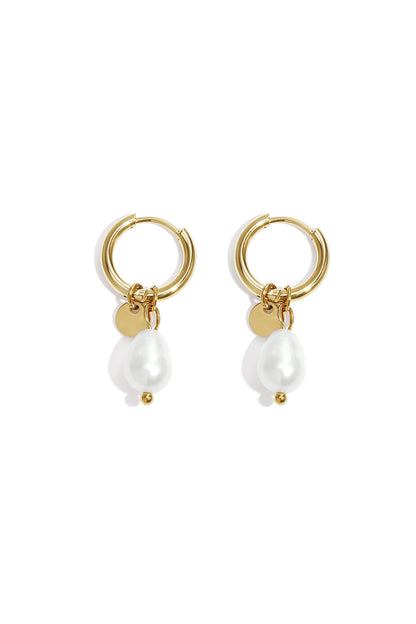 Pair of gold hoop earrings with dangling irregular-shaped white pearls and small gold discs on white background