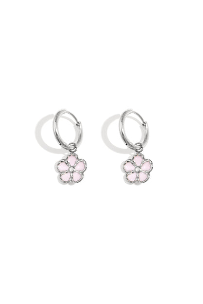 Pair of silver hoop earrings with delicate pink enamel flower charms displayed on a white background