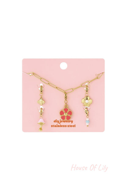 Main Character Petals: Gold-tone stainless steel chain bracelet featuring charms of a pink flower, bee, and mushroom.