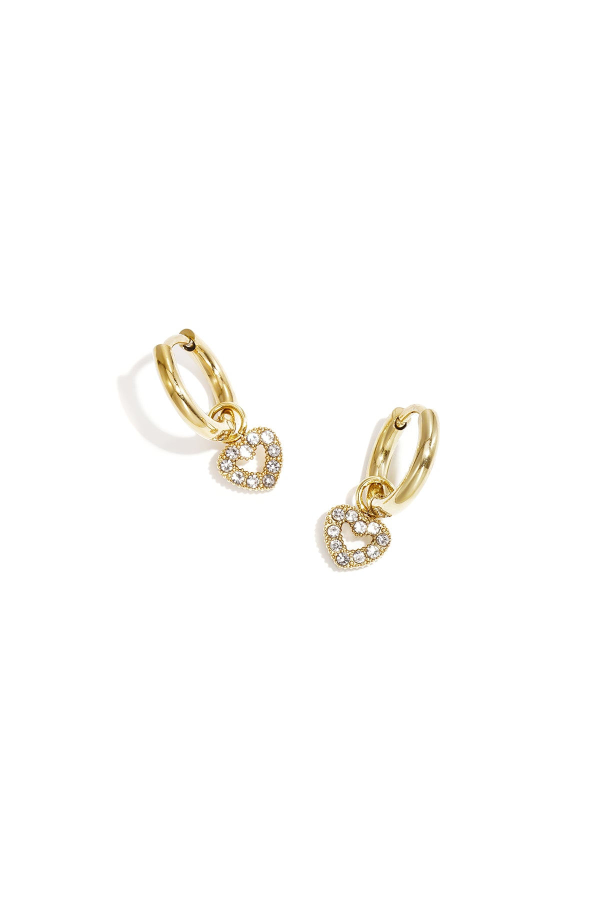 Gold hoop earrings with clear rhinestone outlined heart charm on a white background
