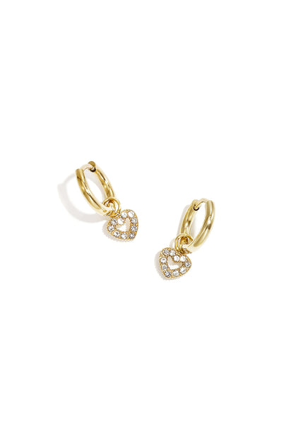 Gold hoop earrings with clear rhinestone outlined heart charm on a white background