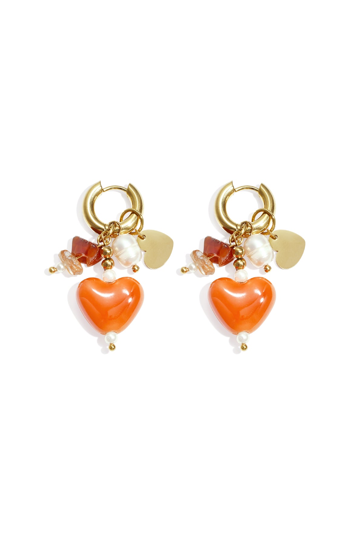 Pair of gold-tone hoop earrings with orange heart charms, natural stones, and faux pearls on white background