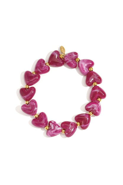 Yellow marbled heart beaded stretch bracelet with gold accent beads on white background