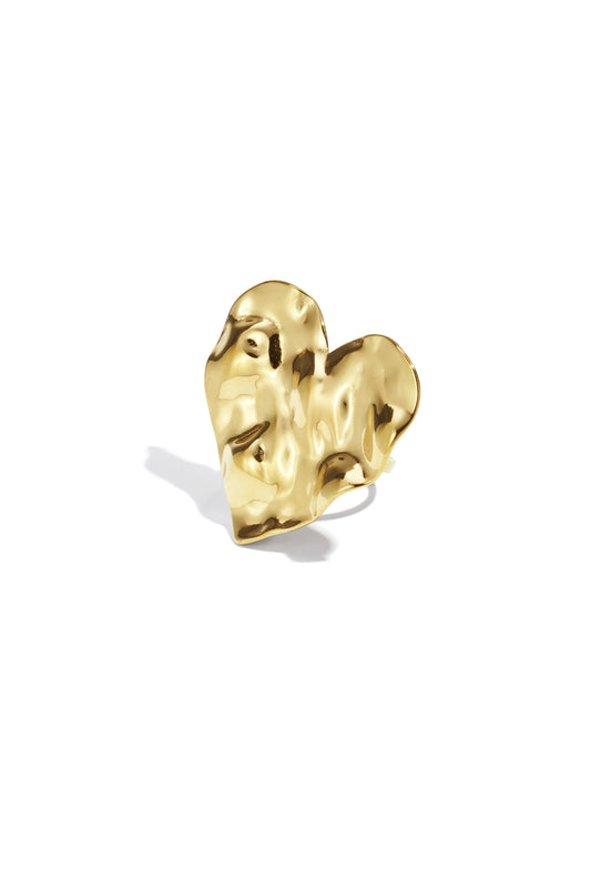 Close-up of golden textured heart statement ring on white background