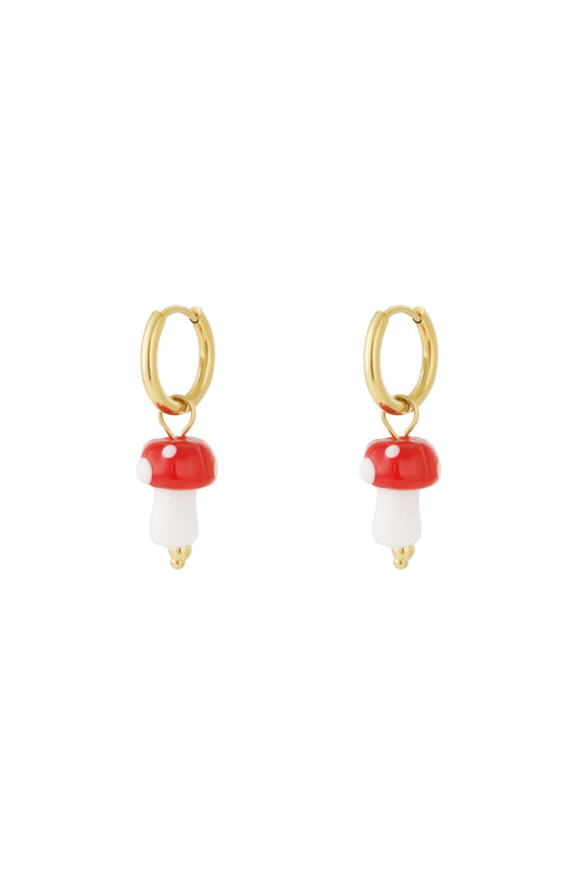Pair of gold hoop earrings with red and white mushroom enamel charms on white background