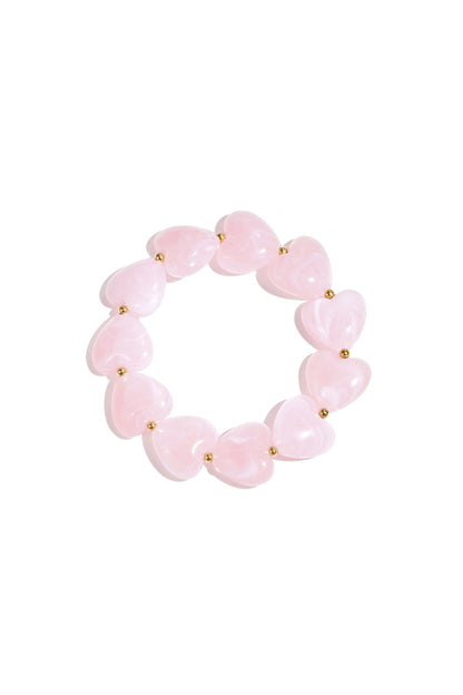 Soft pastel pink marbled heart bead bracelet on white background
