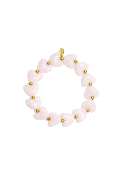 Pink heart beaded stretch bracelet with gold accent beads on white background