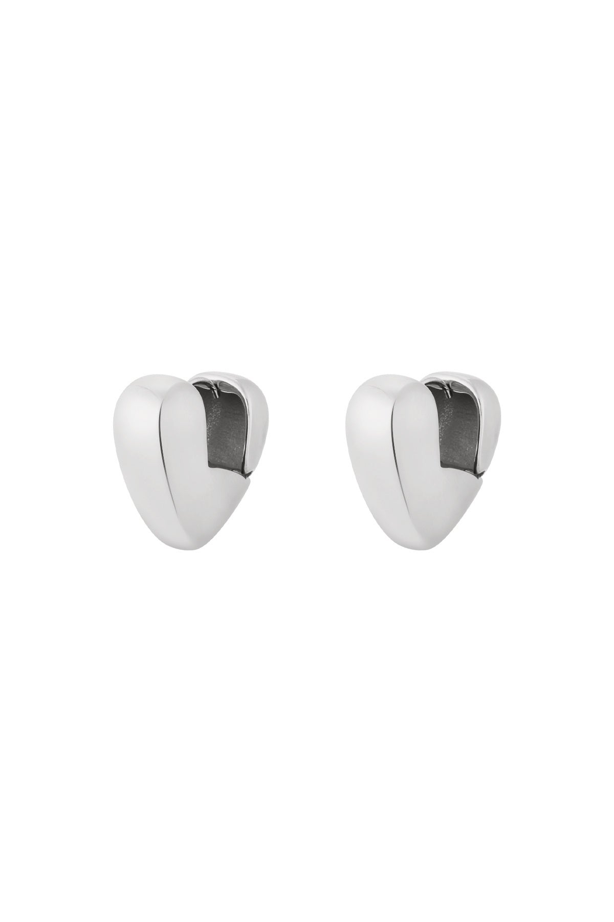 Pair of chunky silver heart-shaped hoop earrings with smooth polished finish isolated on white
