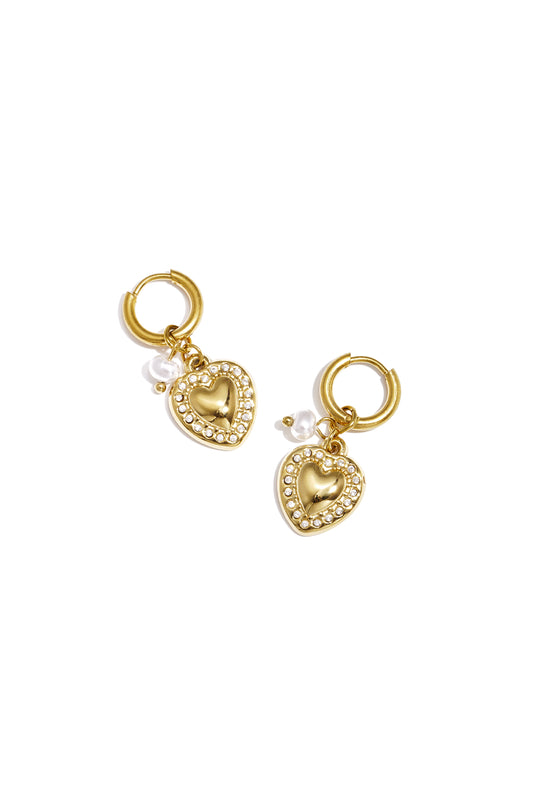 Gold heart drop earrings with rhinestone border and small pearl charm on white background